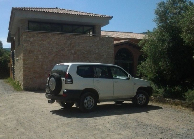 4x4 in front of a stone house